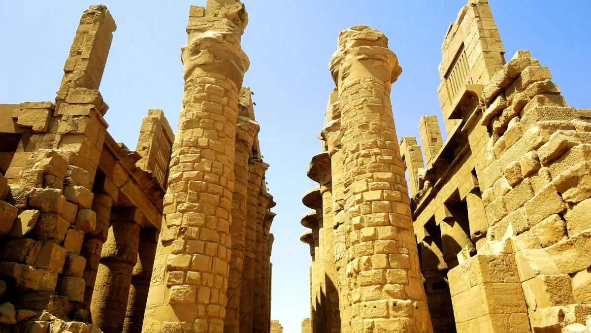 Weathered sandstone columns of the Hypostyle Hall in warm midday light