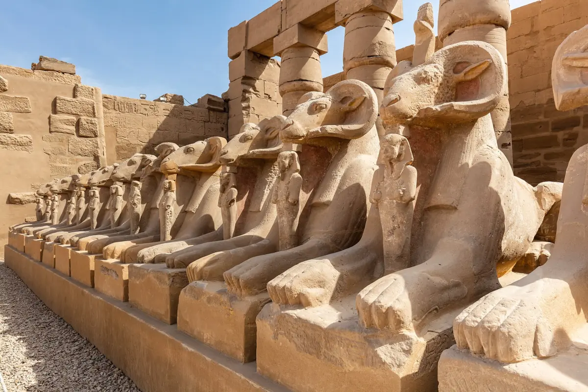 Close view of ram-headed sphinxes lining the entrance path at Karnak
